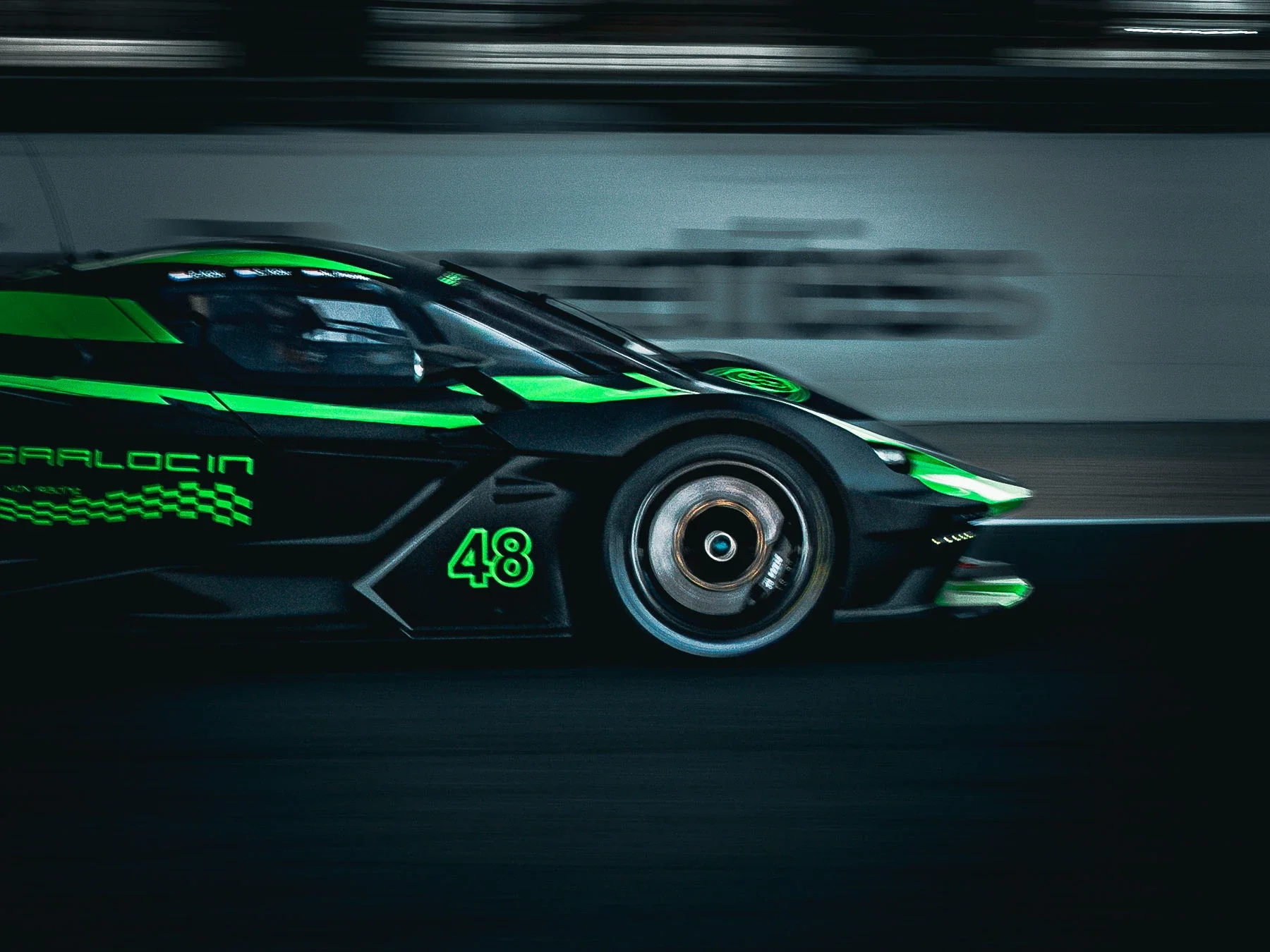 A black race car with green accents speeding on a track, with a visible wheel and racing number 48.