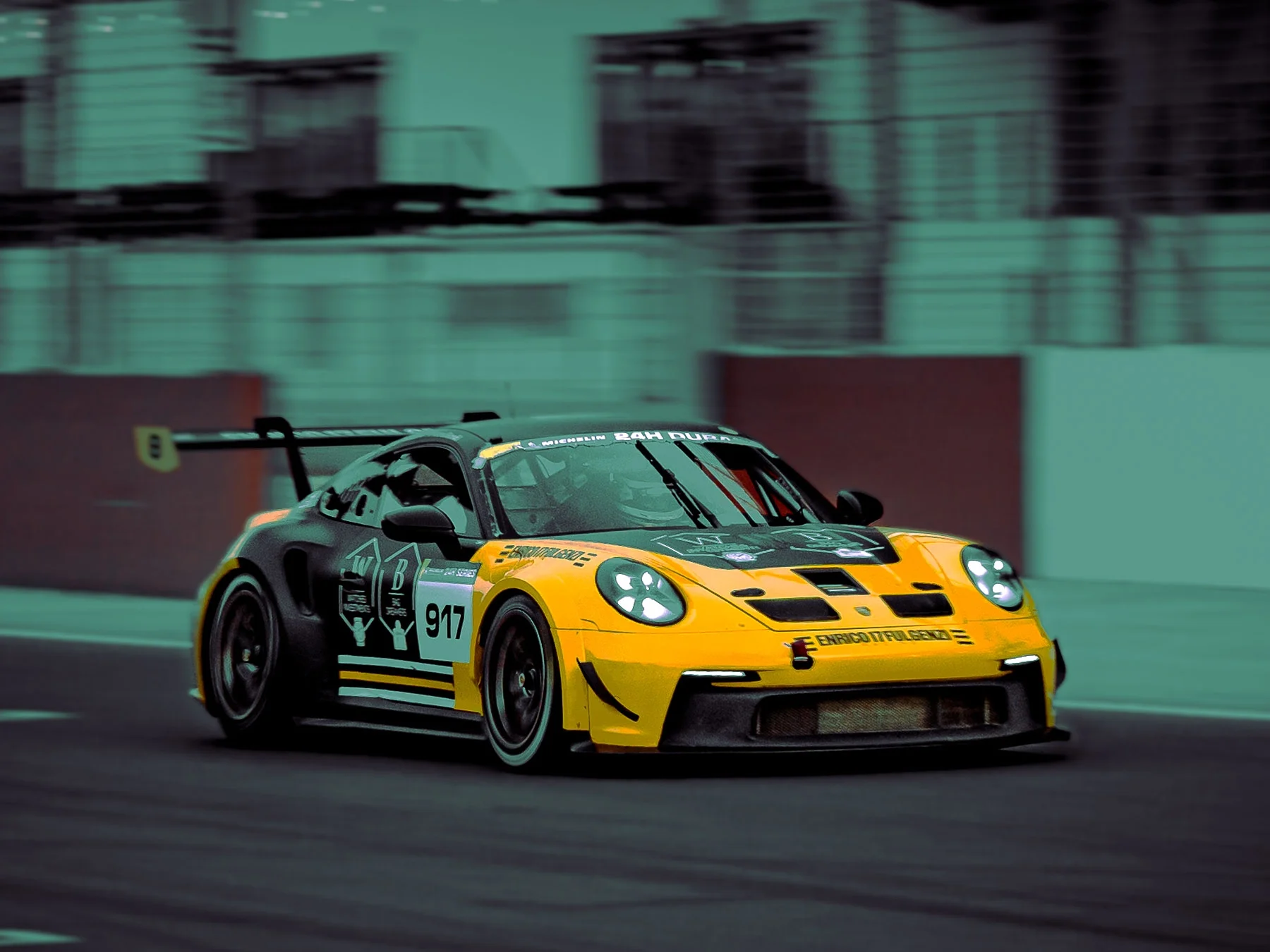 Yellow and black race car on a track during a race.