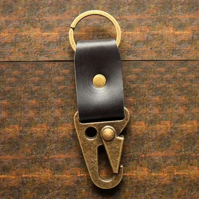 Full-grain leather key clip with sturdy metal clasp, perfect for attaching keys to bags or belts.
