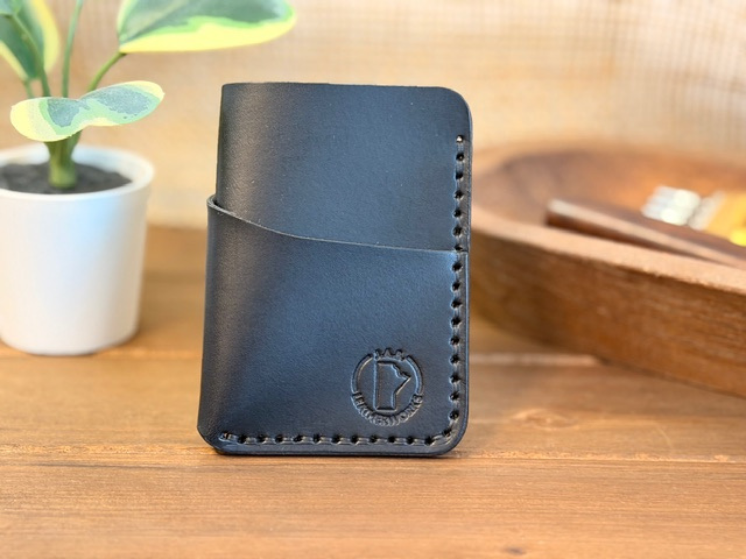 Handcrafted full-grain leather vertical card holder with slim, compact design for everyday carry.