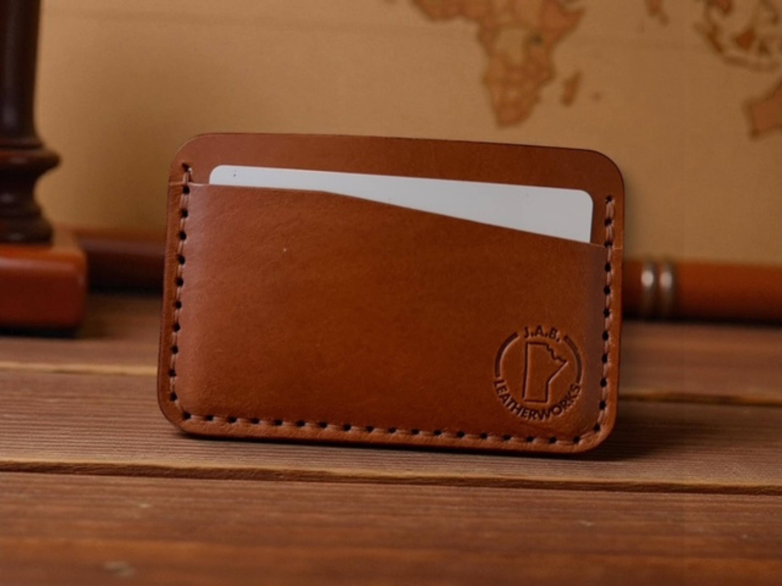Full-grain leather horizontal card holder with sleek minimalist design, ideal for holding credit cards and ID.