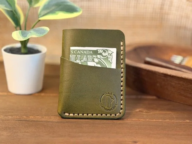 Handcrafted full-grain leather vertical card holder with slim, compact design for everyday carry.