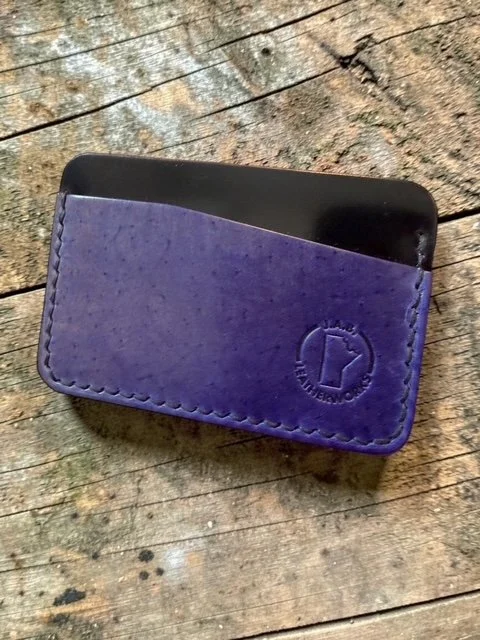horizontal card holder handcrafted from Rocado shell cordovan, showing deep violet front panel and near-black reverse, with J.A.B. Leatherworks stamp