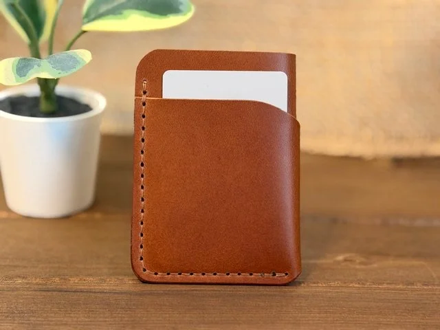 Handcrafted full-grain leather vertical card holder with slim, compact design for everyday carry.
