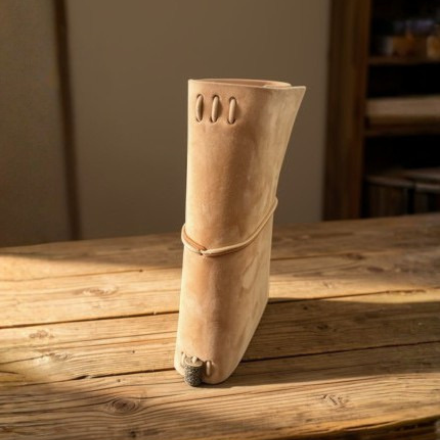Natural suede Field Notes tri-fold cover with cord closure on a wood table, handmade by JAB Leatherworks
