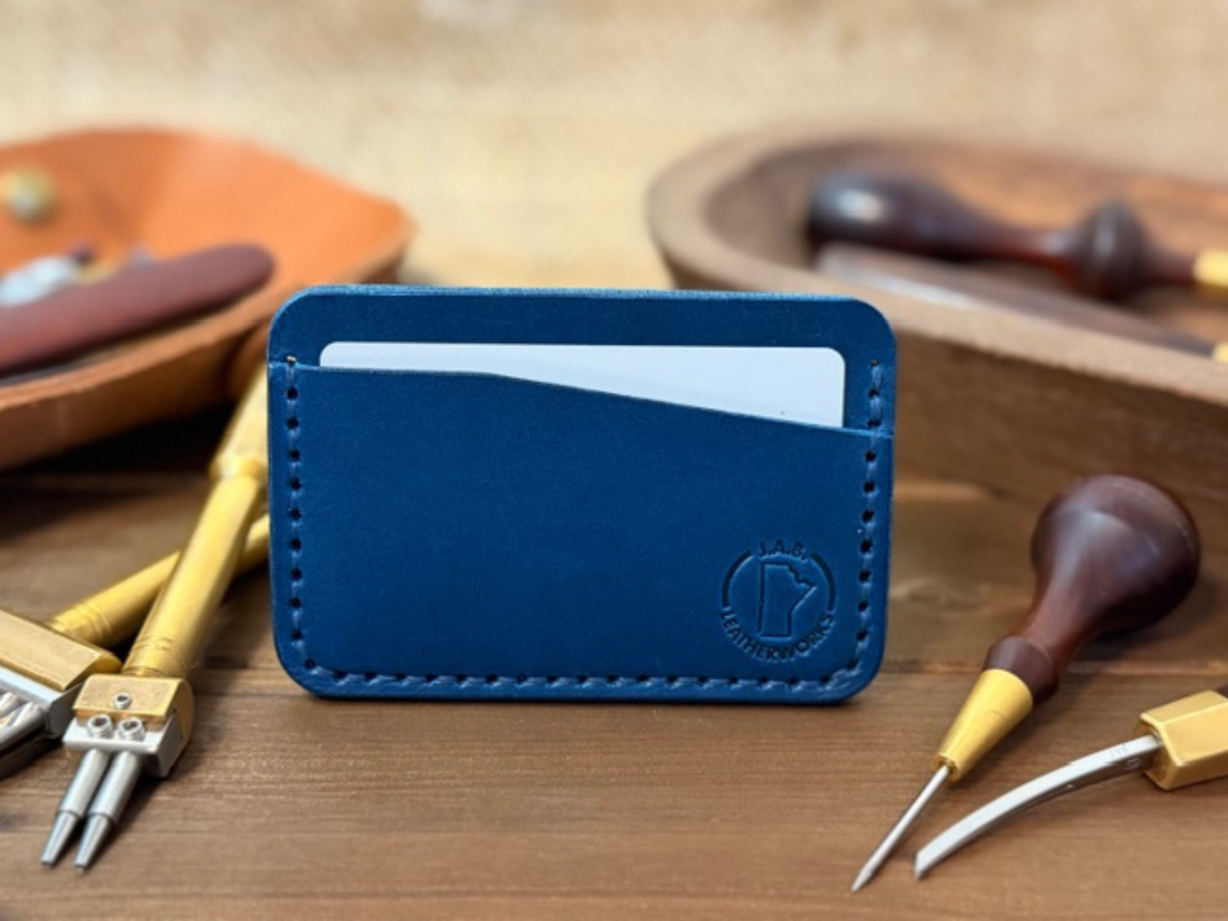 Full-grain leather horizontal card holder with sleek minimalist design, ideal for holding credit cards and ID.