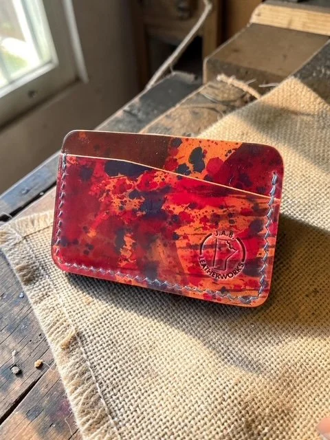Rocado art shell cordovan horizontal card holder in crimson, burnt orange, and deep violet, handcrafted by J.A.B. Leatherworks, Canada.