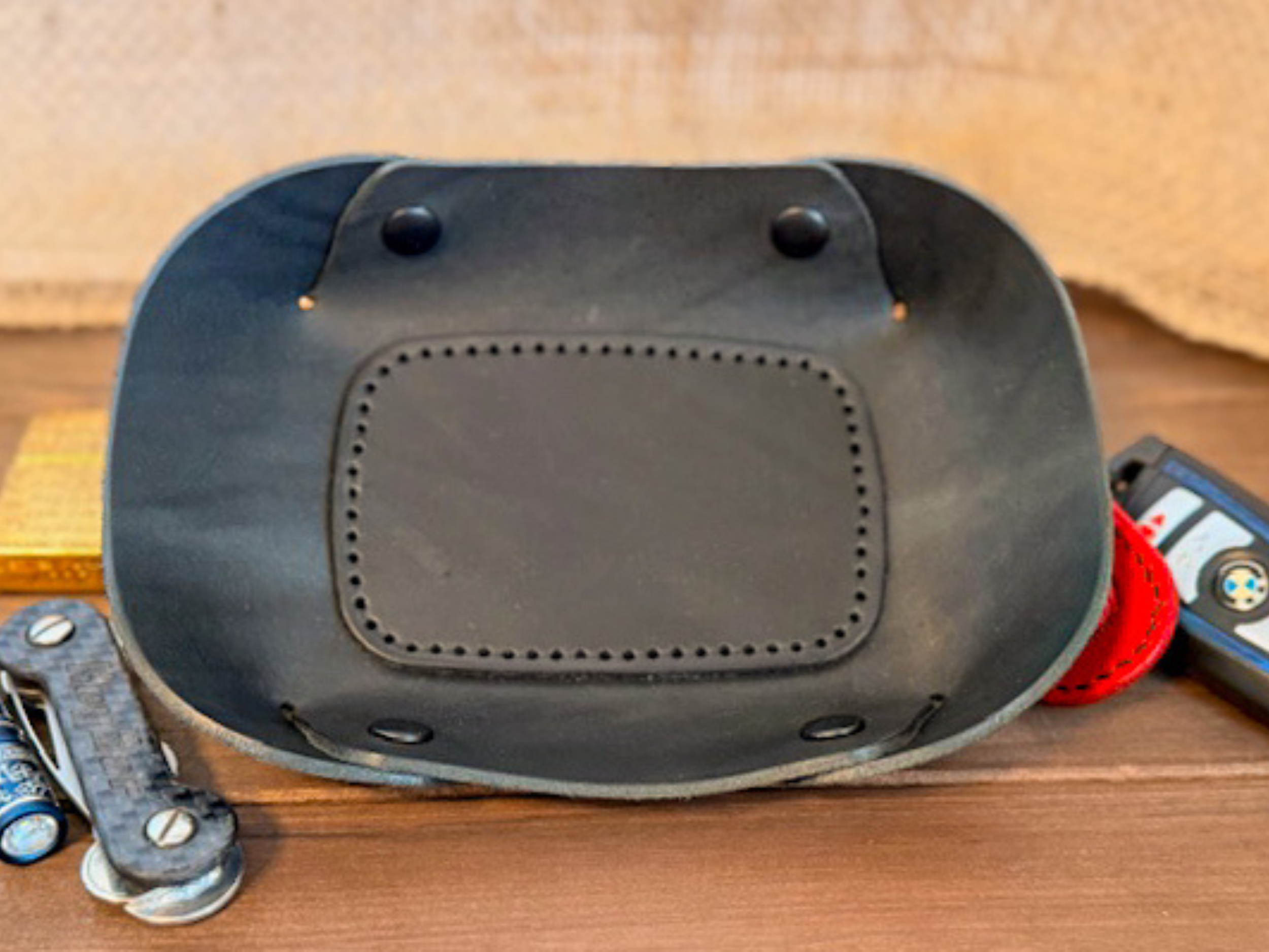 Handcrafted leather valet tray with stitched edges, perfect for holding keys, coins, and everyday essentials.