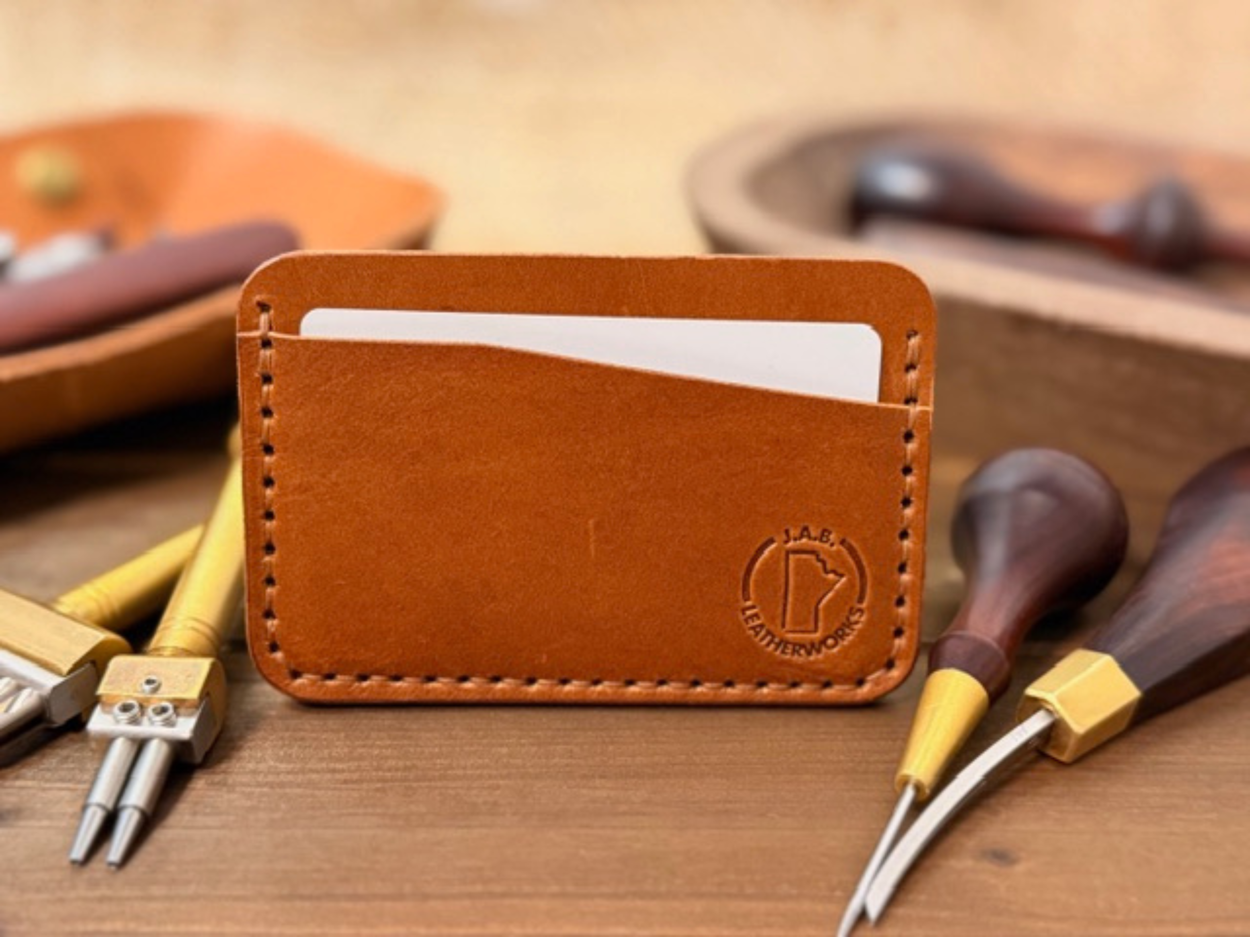 Full-grain leather horizontal card holder with sleek minimalist design, ideal for holding credit cards and ID.