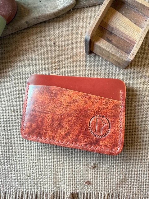 No. 60 — Rocado art shell cordovan horizontal card holder with smooth brick red back panel and mottled terracotta and rust art shell front, handcrafted by J.A.B. Leatherworks, Canada.