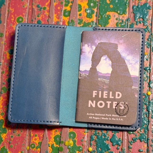 Full-grain leather folio designed for Field Notes notebooks, with interior pockets for pens and cards.