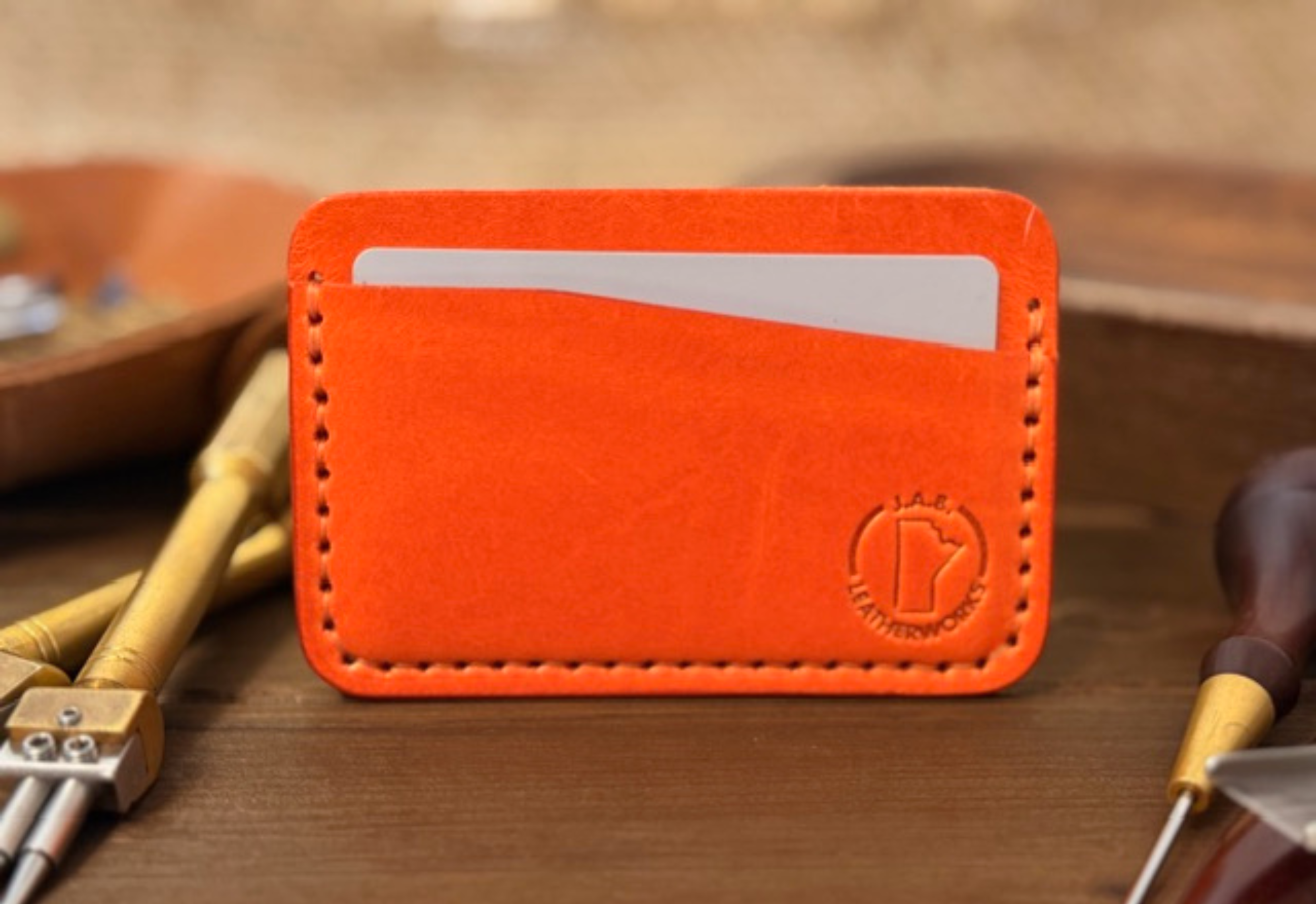 Full-grain leather horizontal card holder with sleek minimalist design, ideal for holding credit cards and ID.