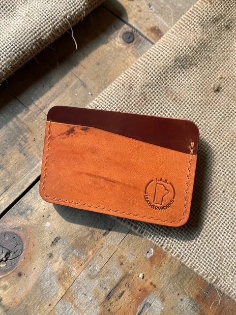 Horween shell cordovan horizontal card holder showing grain and flesh sides of the same hide in warm amber tan and deep burgundy, handcrafted by J.A.B. Leatherworks, Canada.