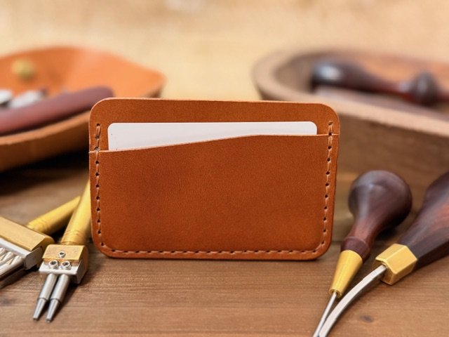 Full-grain leather horizontal card holder with sleek minimalist design, ideal for holding credit cards and ID.