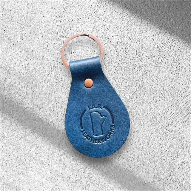 Durable leather keychain with metal hardware, handcrafted for everyday use and easy carrying of keys.