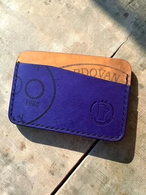 horizontal card holder handcrafted from Rocado shell cordovan, showing deep violet front panel and warm natural tan reverse with Rocado stamp, handcrafted by J.A.B. Leatherworks