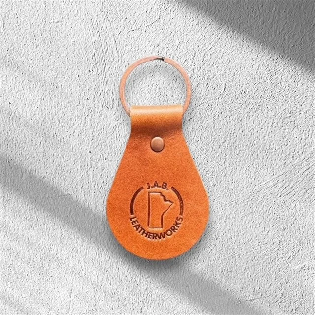 Durable leather keychain with metal hardware, handcrafted for everyday use and easy carrying of keys.