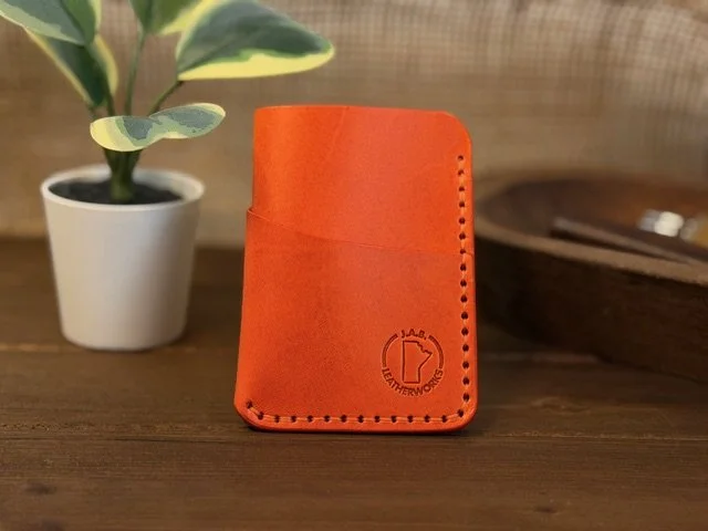 Handcrafted full-grain leather vertical card holder with slim, compact design for everyday carry.