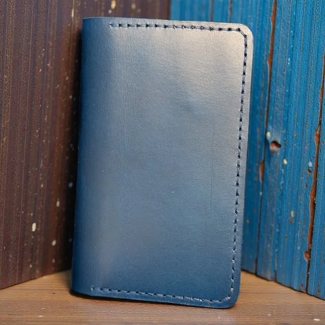 Full-grain leather folio designed for Field Notes notebooks, with interior pockets for pens and cards.