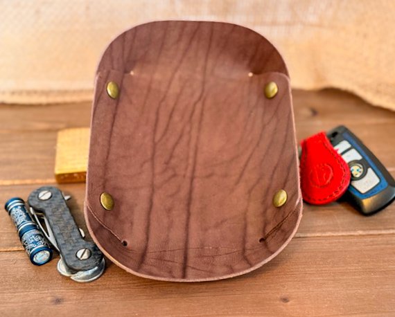 Handcrafted leather valet tray with stitched edges, perfect for holding keys, coins, and everyday essentials.