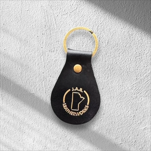 Durable leather keychain with metal hardware, handcrafted for everyday use and easy carrying of keys.