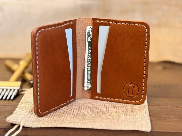 Premium full-grain leather bifold wallet with multiple card slots and cash compartment, handcrafted for durability