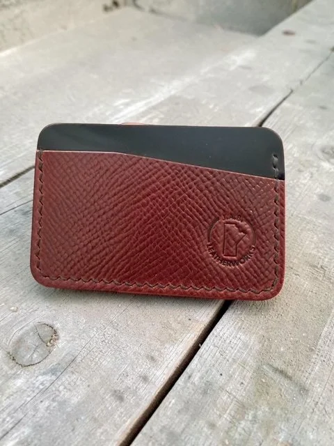 horizontal card holder handcrafted from Rocado shell cordovan, showing rich burgundy hatch grain front panel and near-black reverse, with J.A.B. Leatherworks stamp