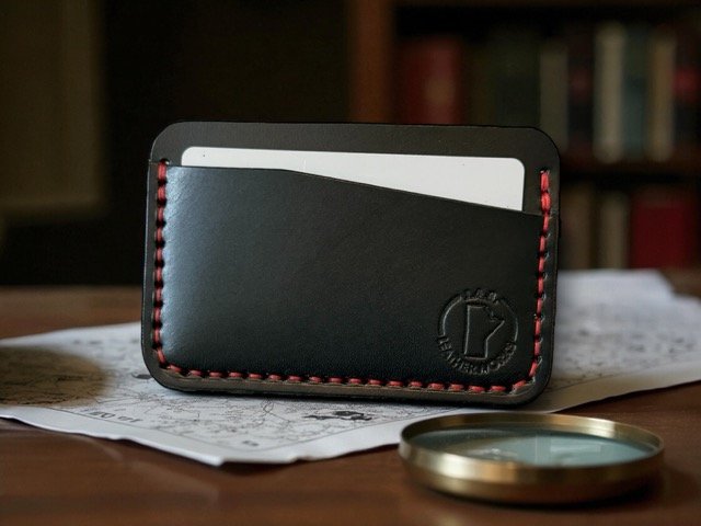 Full-grain leather horizontal card holder with sleek minimalist design, ideal for holding credit cards and ID.