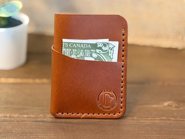 Handcrafted full-grain leather vertical card holder with slim, compact design for everyday carry.