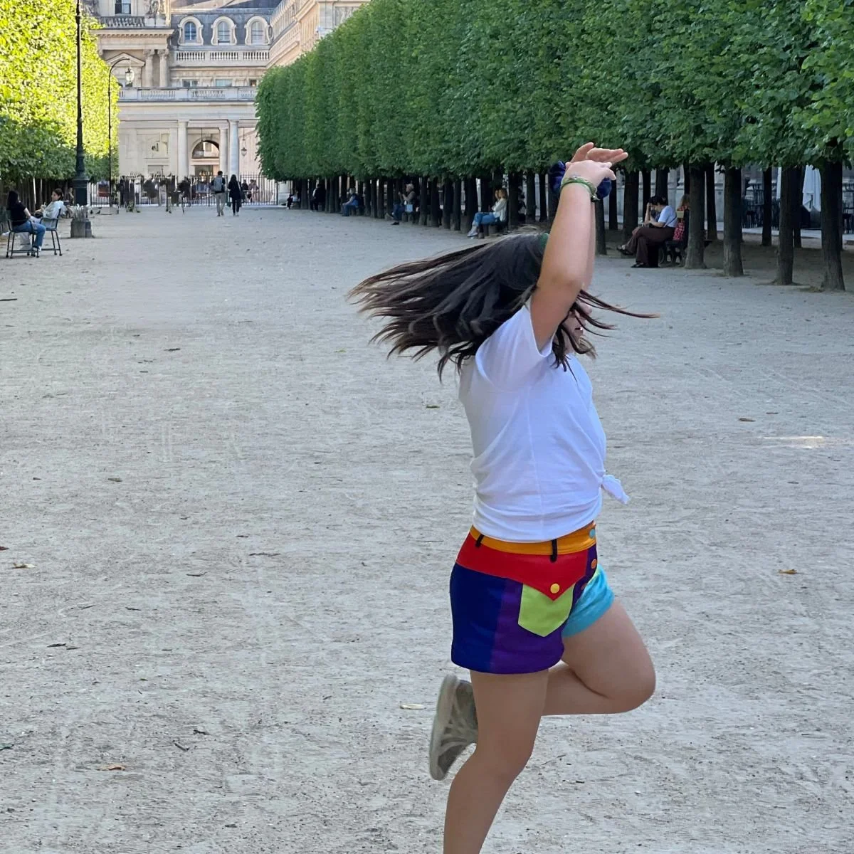 A girl dancing at a park in Paris France