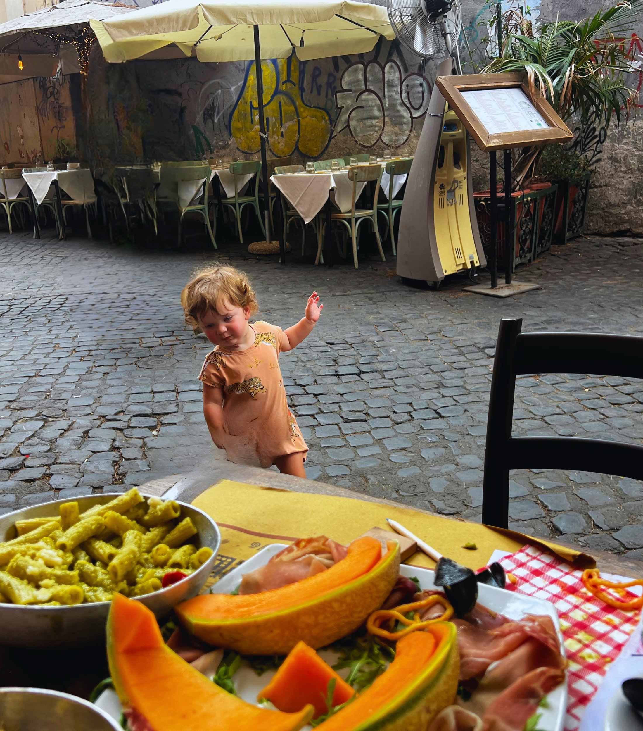 Child in Rome eating outside at a restaurant