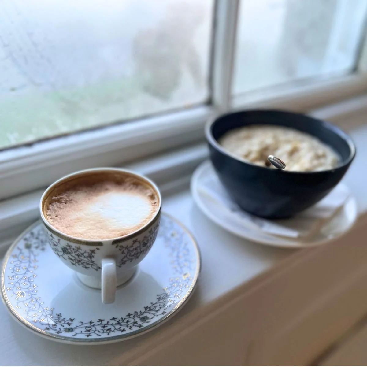 Oatmeal and a cup of coffee on a window sill in Ireland