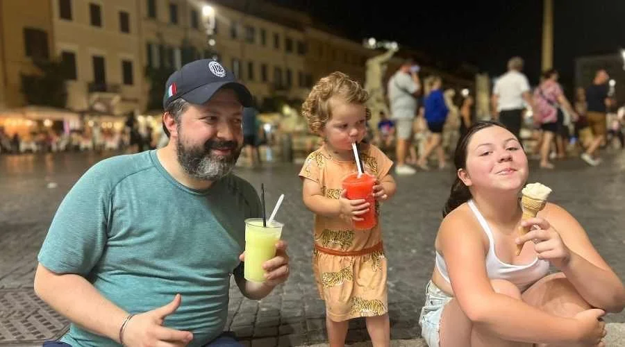 A father with his two daughters drinking Italian Ice in Rome Italy