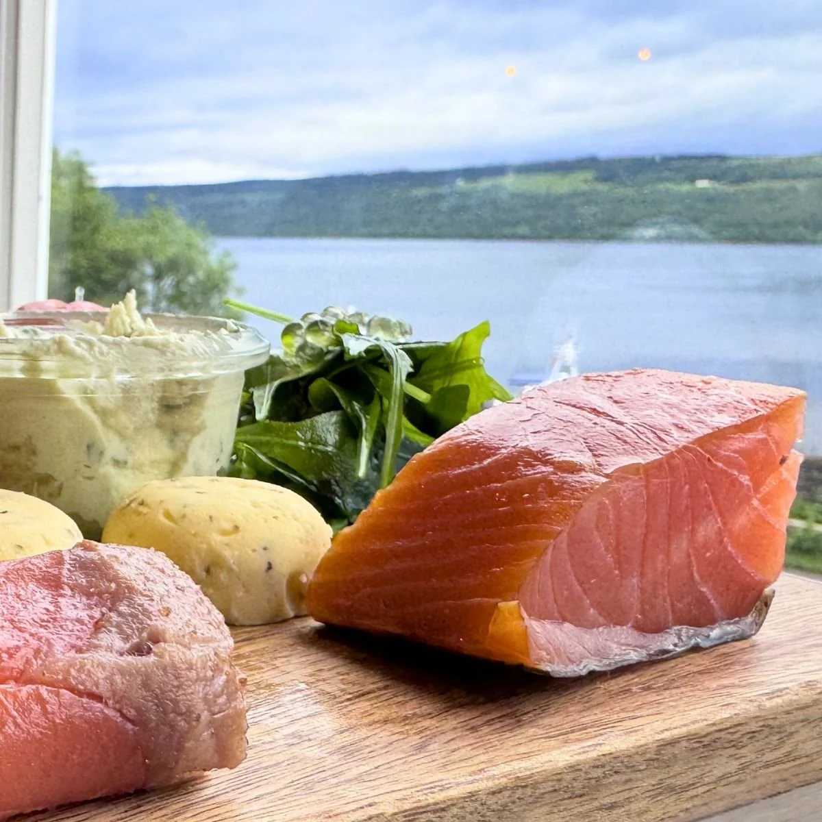 A plate of smoked salmon overlooking the Loc Ness in Scotland