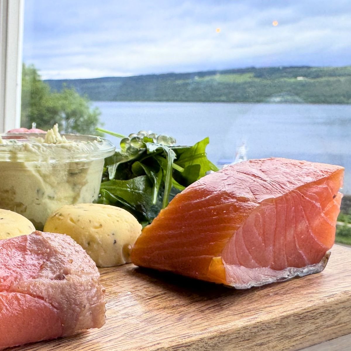 A plate of smoked salmon overlooking the Loc Ness in Scotland