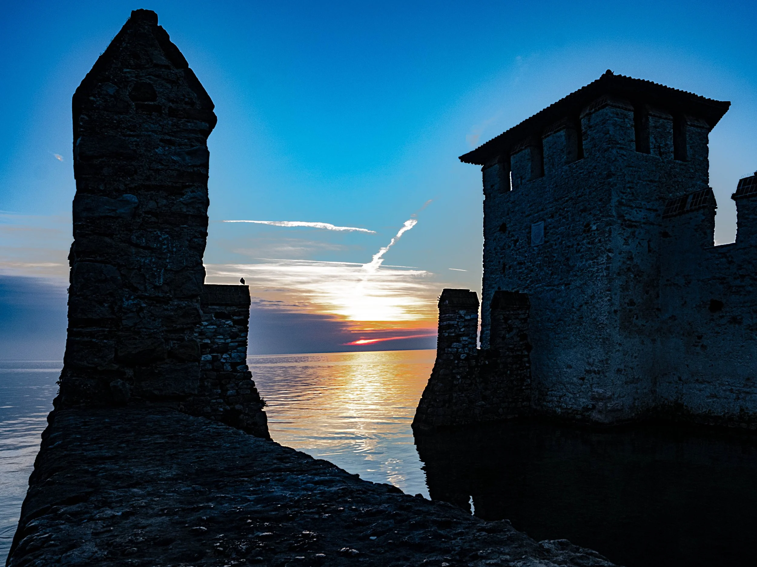 Italy • Sirmione, Lake Garda • Scaligero Castle • Sunrise behind castle towers • Feb 2, 2024