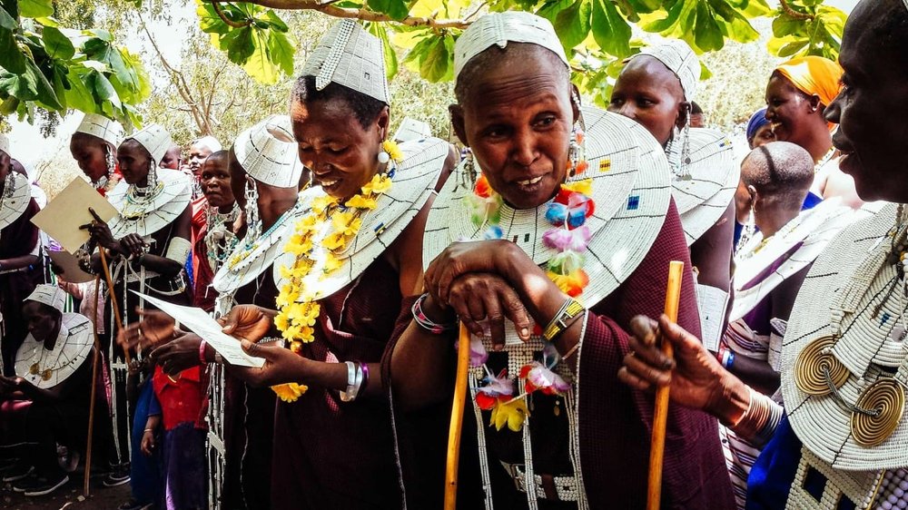 Perpetua-and-members-of-Namnyak-womens-group-chat-and-admire-their-new-certificates.jpg