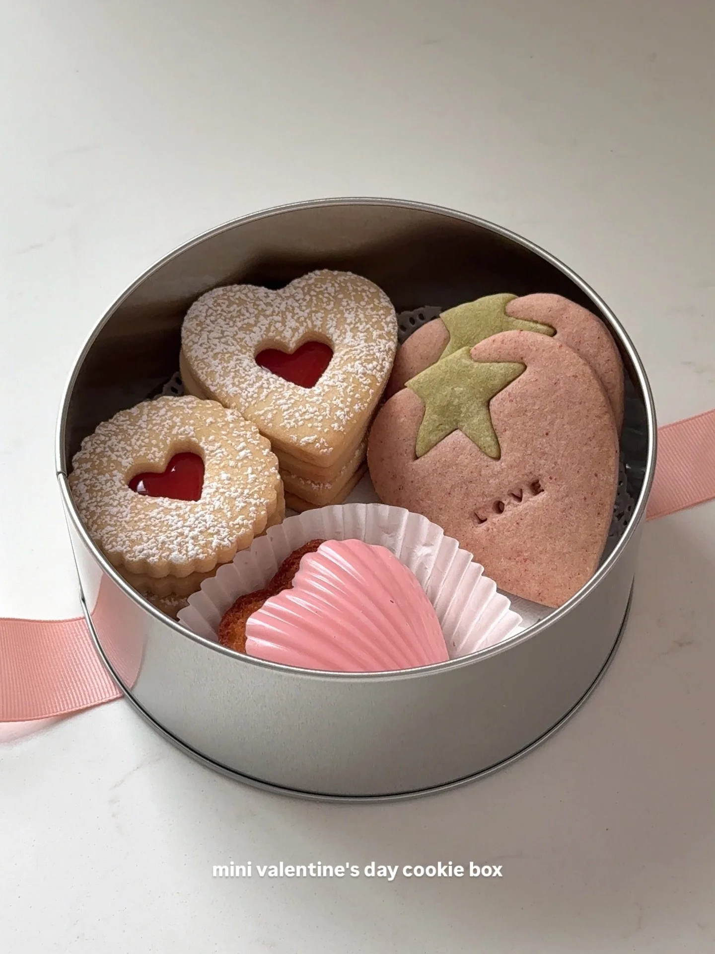 let's make a mini valentine's day cookie box 🩷

made some of my favorite simple cookies, valentine's day edition: guava jam linzer cookies, strawberry shaped strawberry matcha butter cookies, &amp; salty vanilla bean heart madeleine with pink chocol