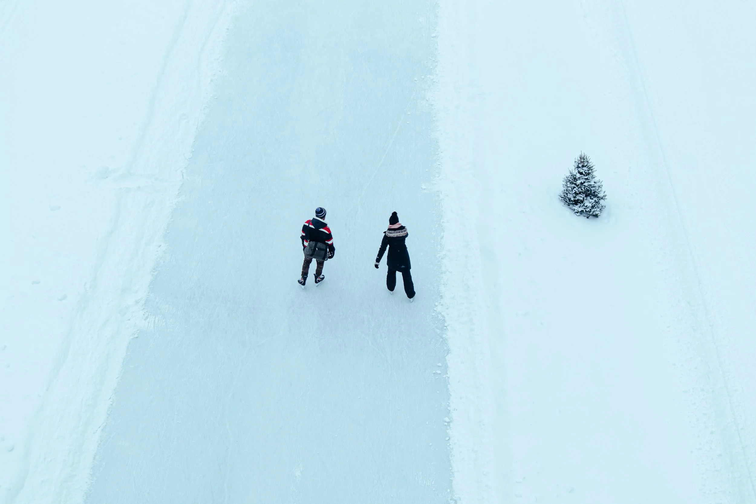 Two people skating on the frozen Assiniboine River