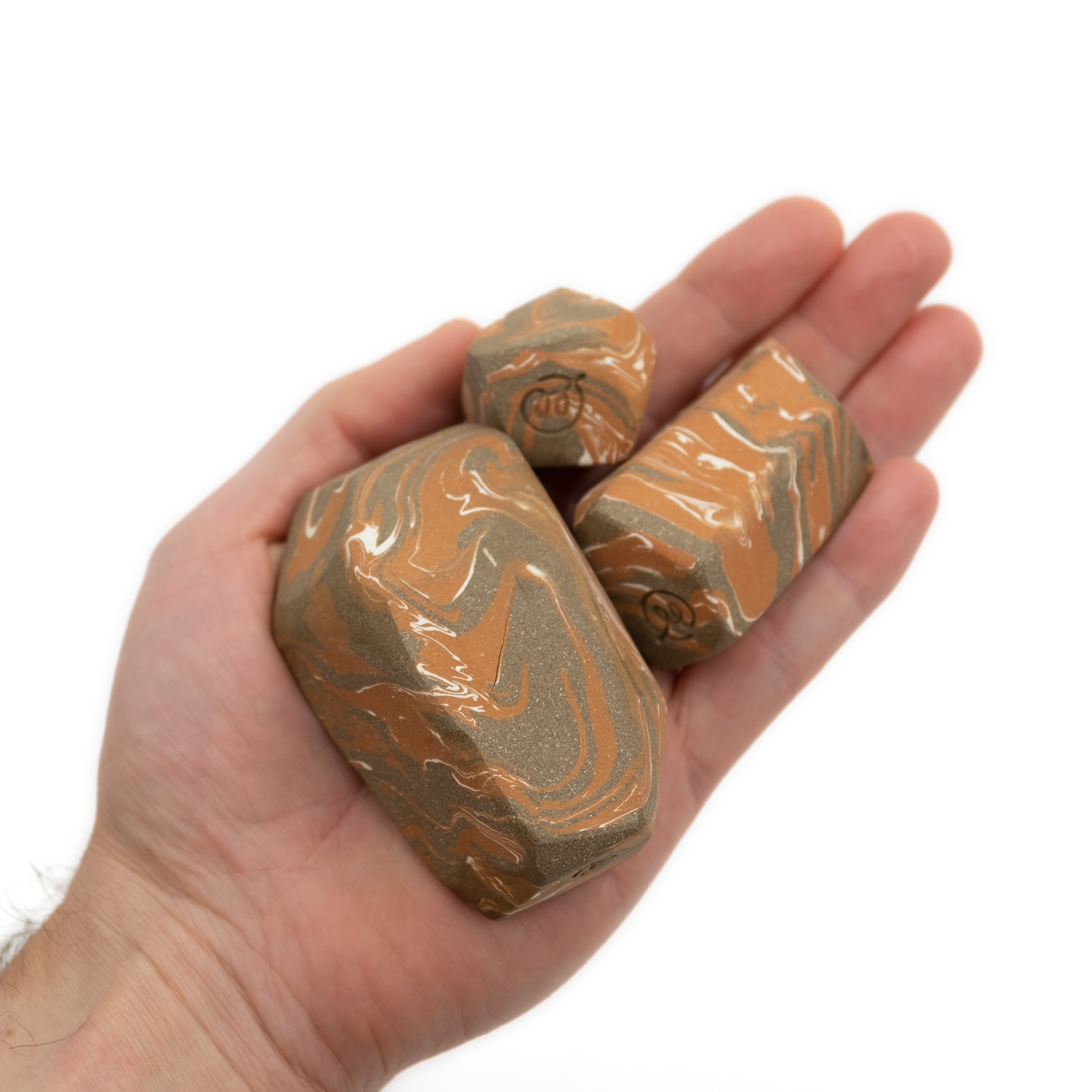 Various sizes of Fidget Stone 02 in hand.