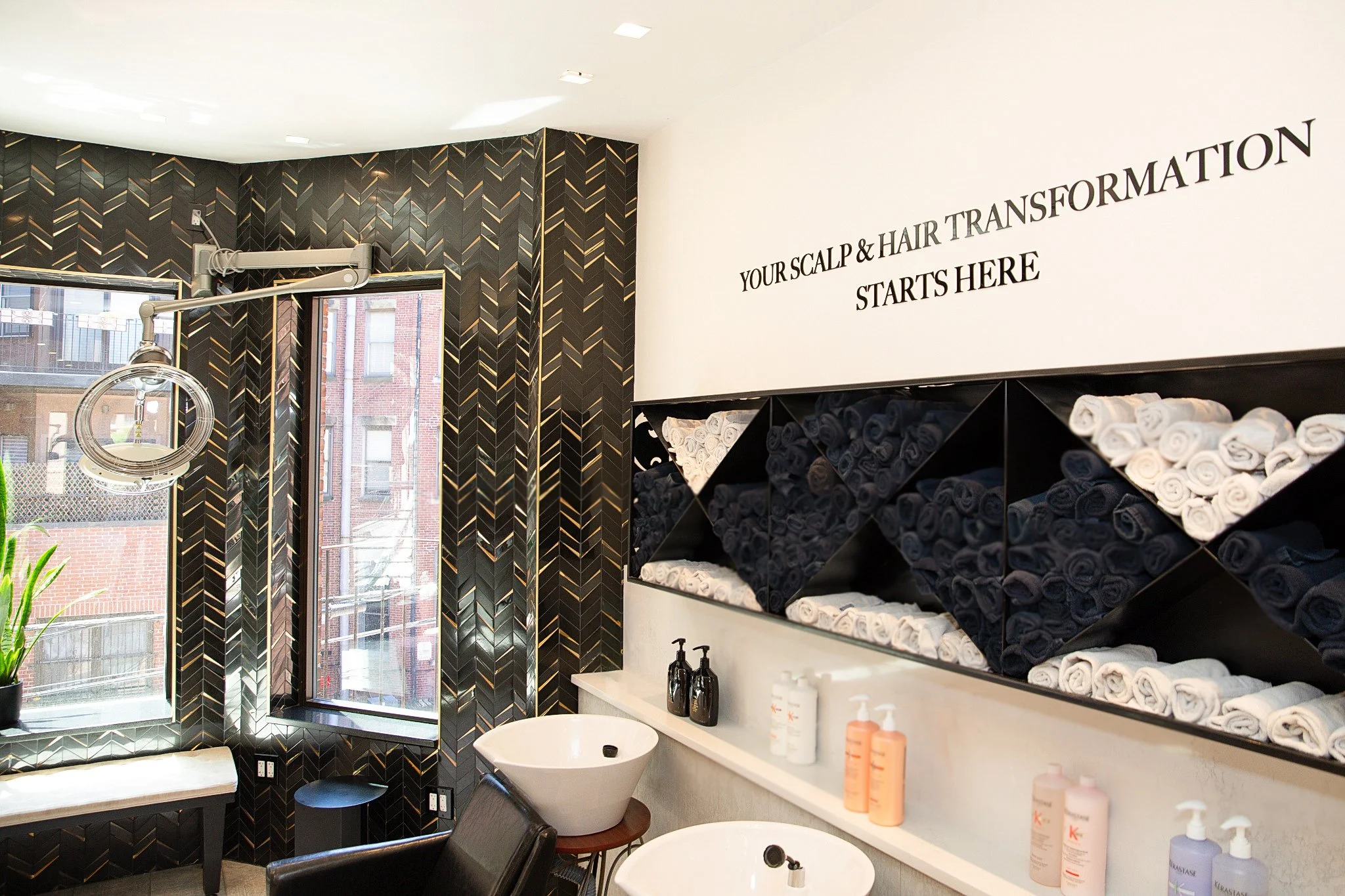 view of shampoo area with products and tile feature wall