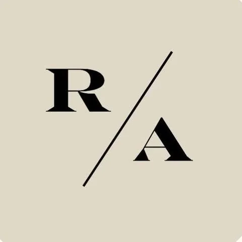 Minimalist design with the letter R and A separated by a slash on a light beige background.