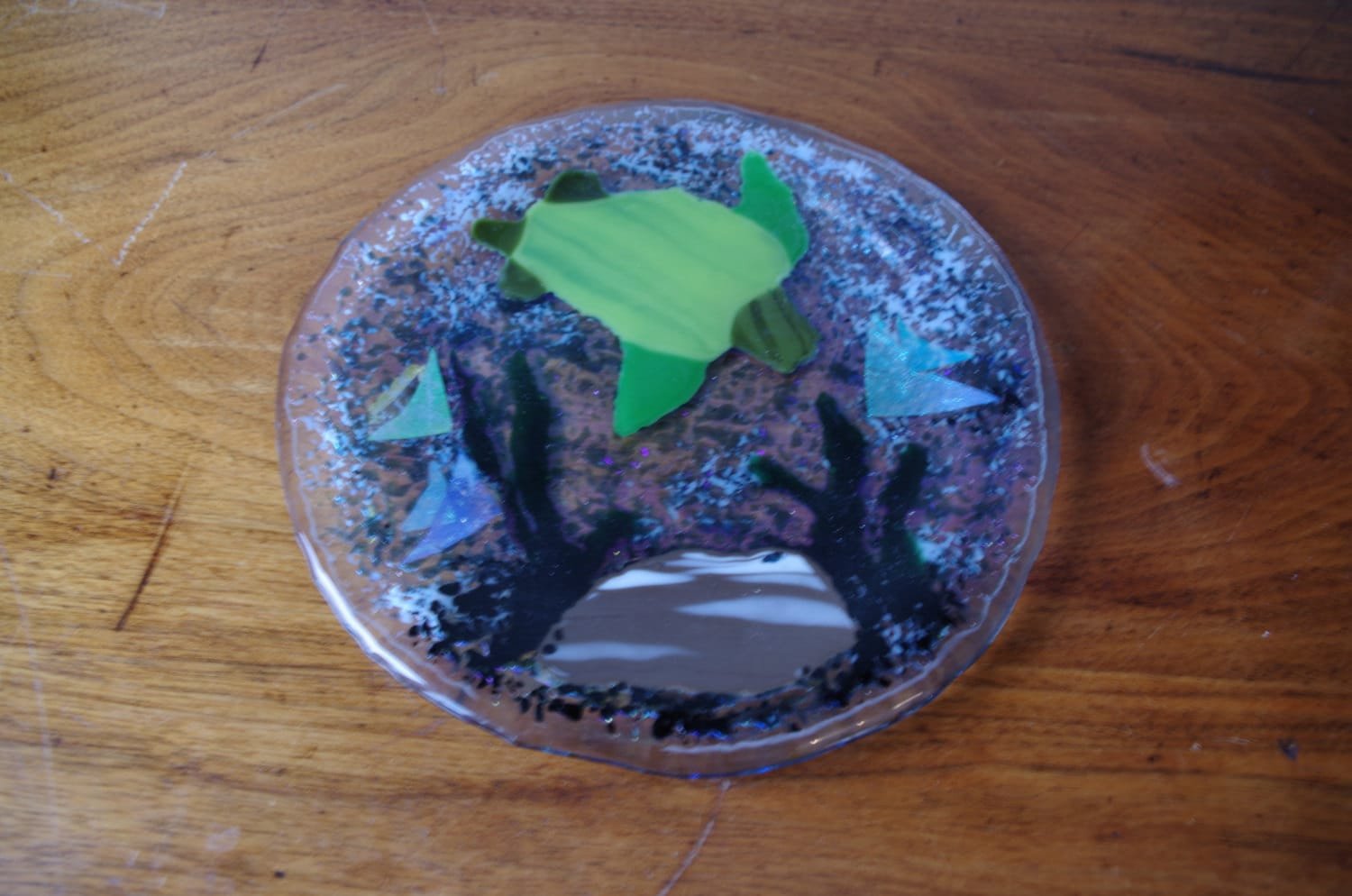 Decorative plate with a undersea motif.  Sea turtle in an iridescent ocean.