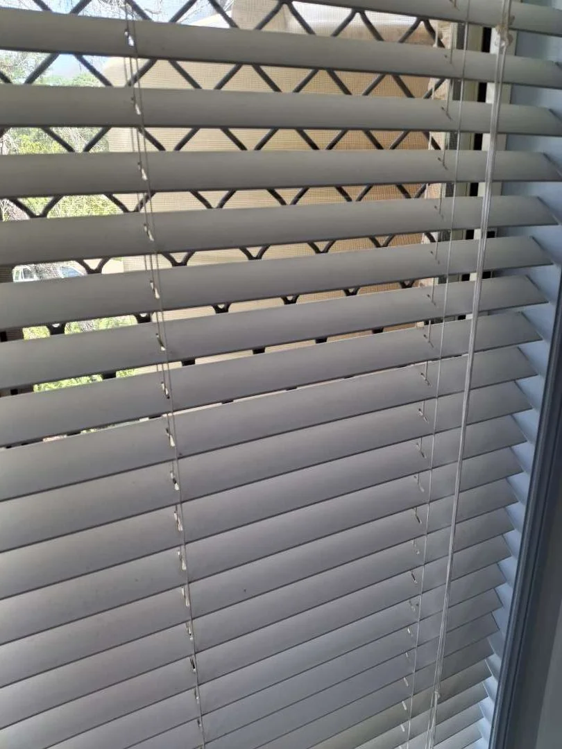 An "after" photo, showing a set of freshly cleaned venetian blinds.