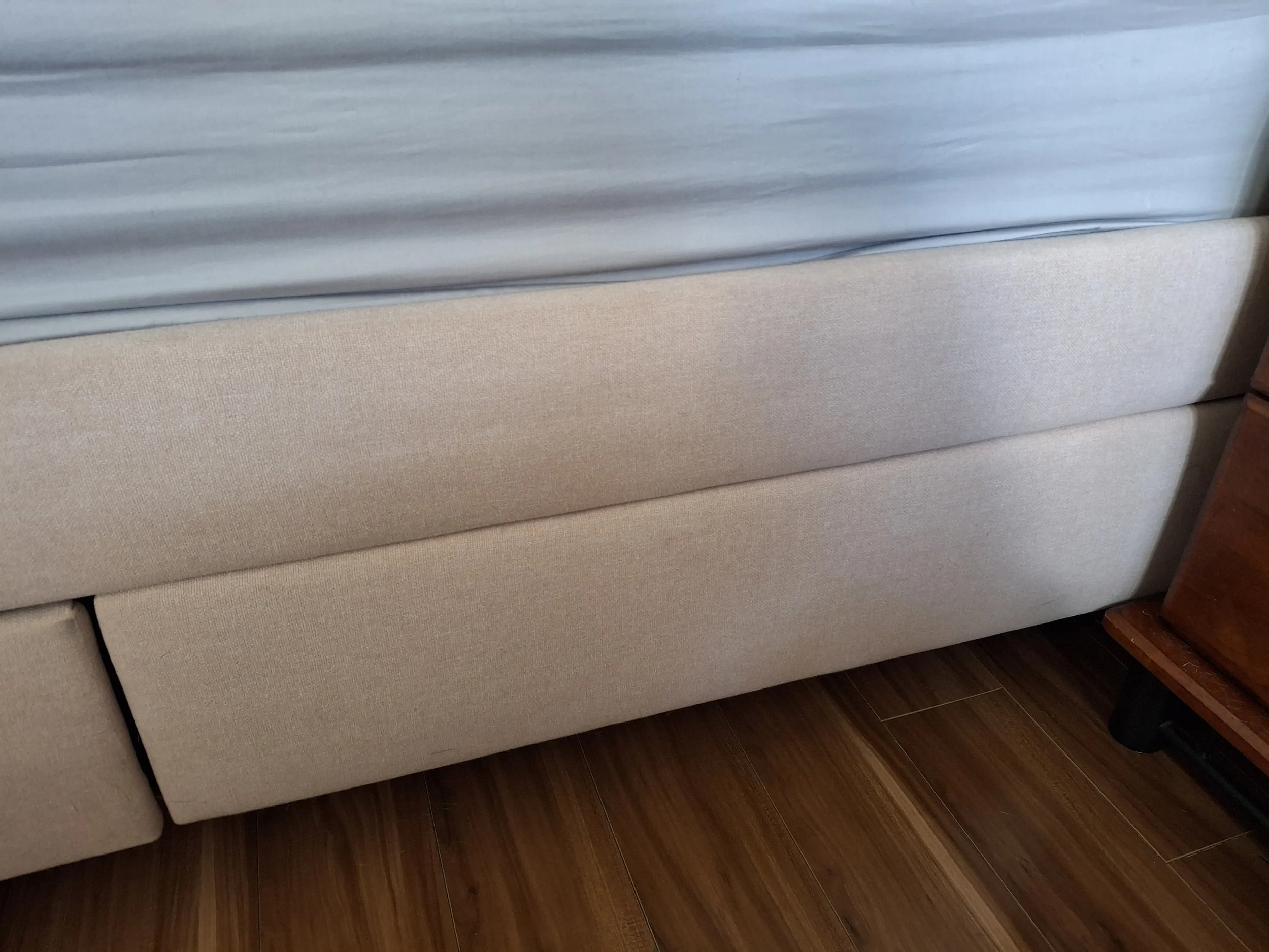 An "after" photo, showing a freshly cleaned upholstered bed