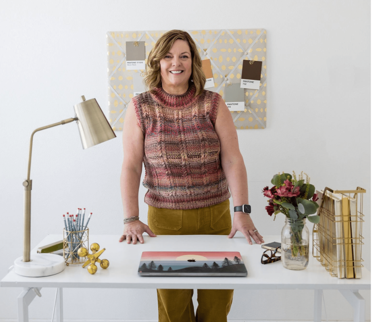 Jennifer Mager standing at her desk in home office