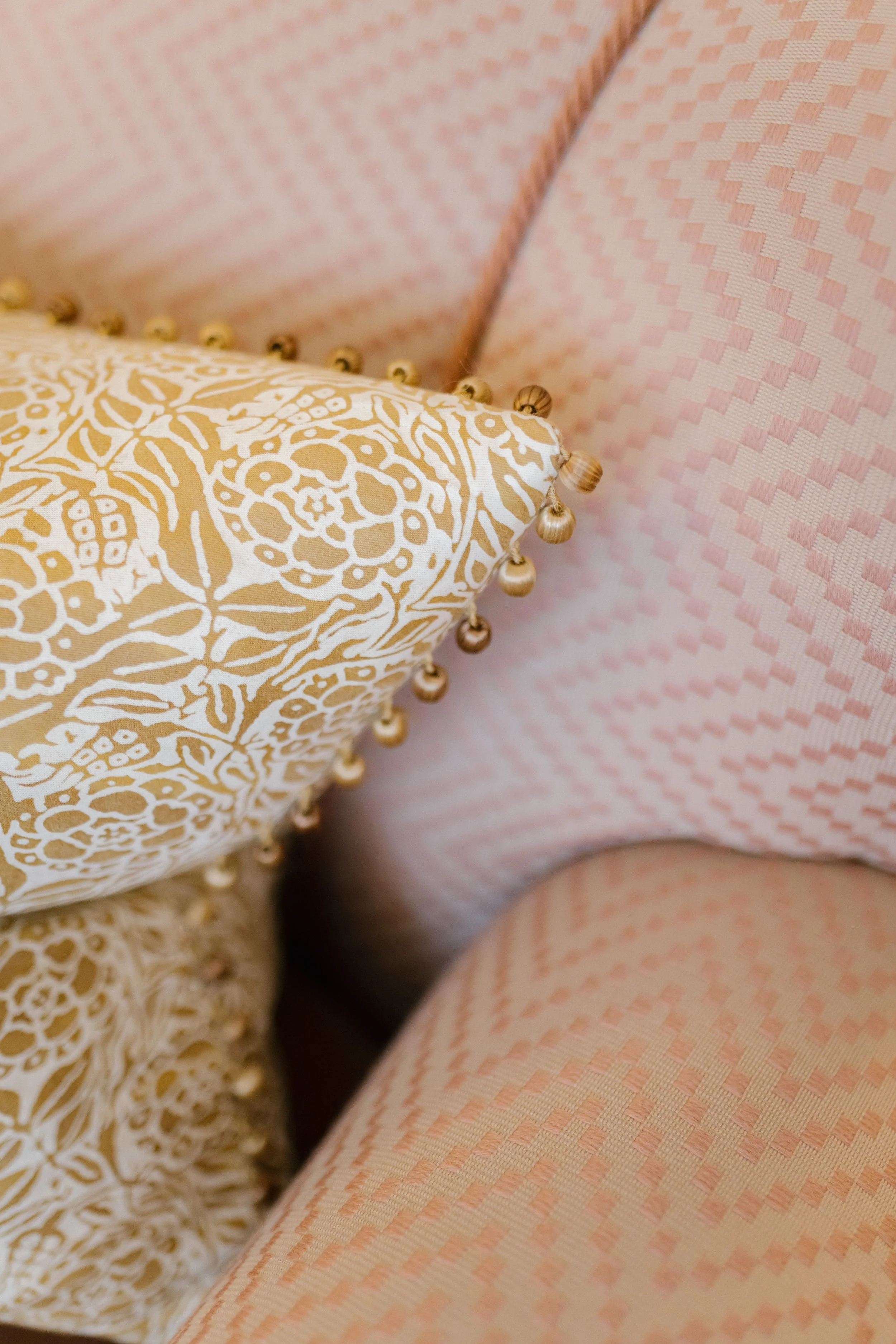 patterned pillow and two plain pillows