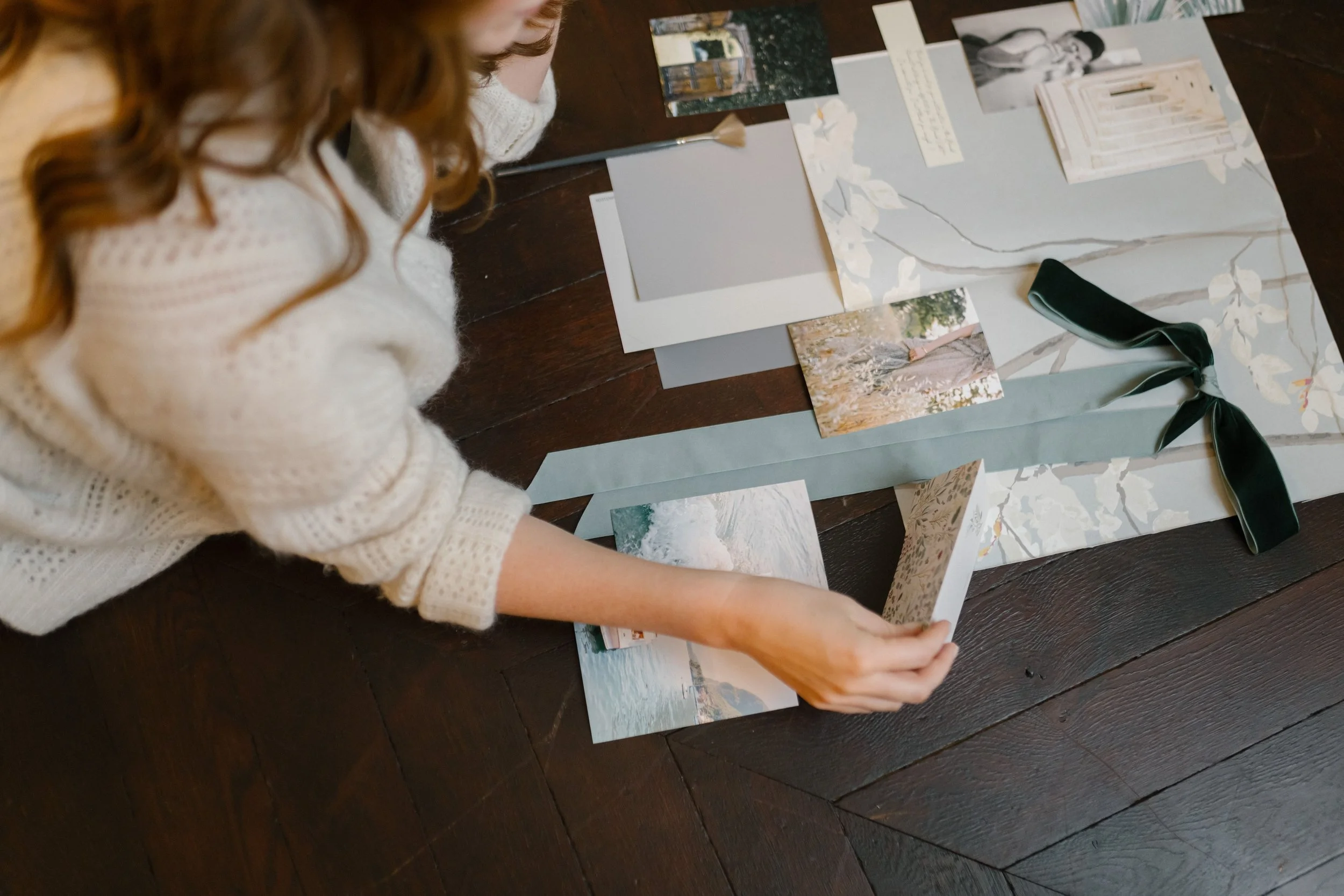 woman creating vision board collage on the floor