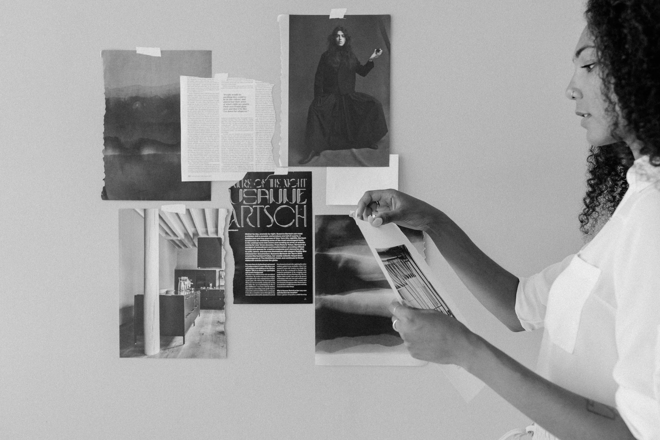 woman creating design collage on wall
