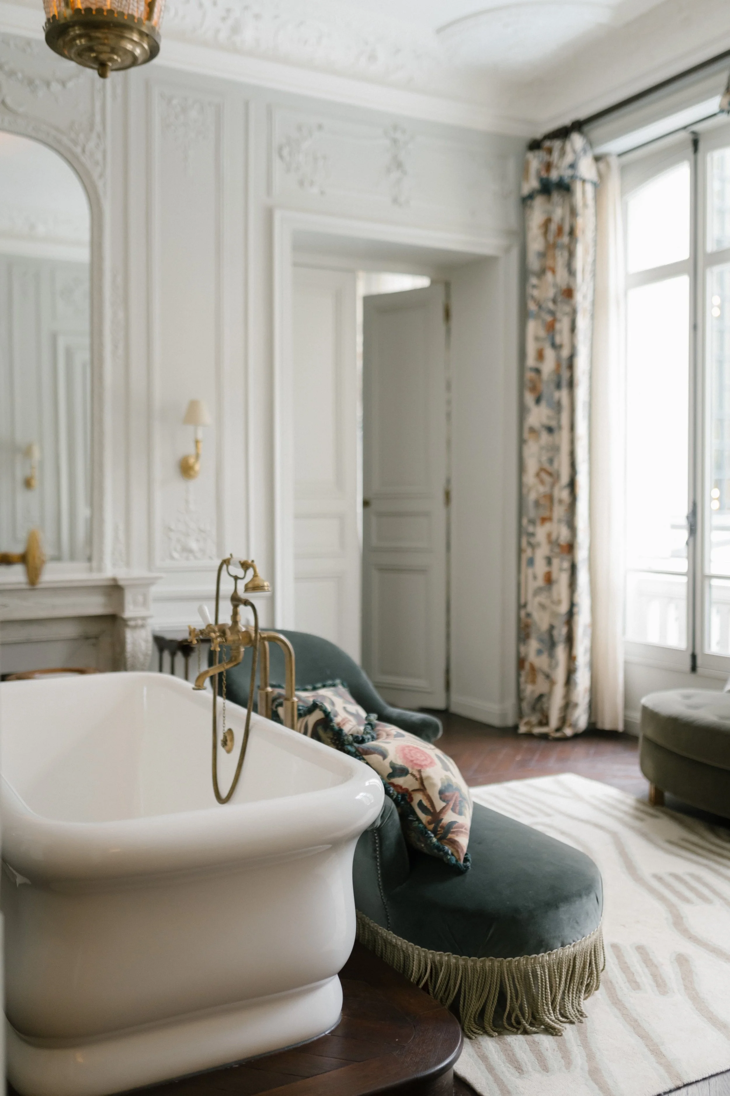 elegant old fashioned bathtub and sofa with patterned pillows